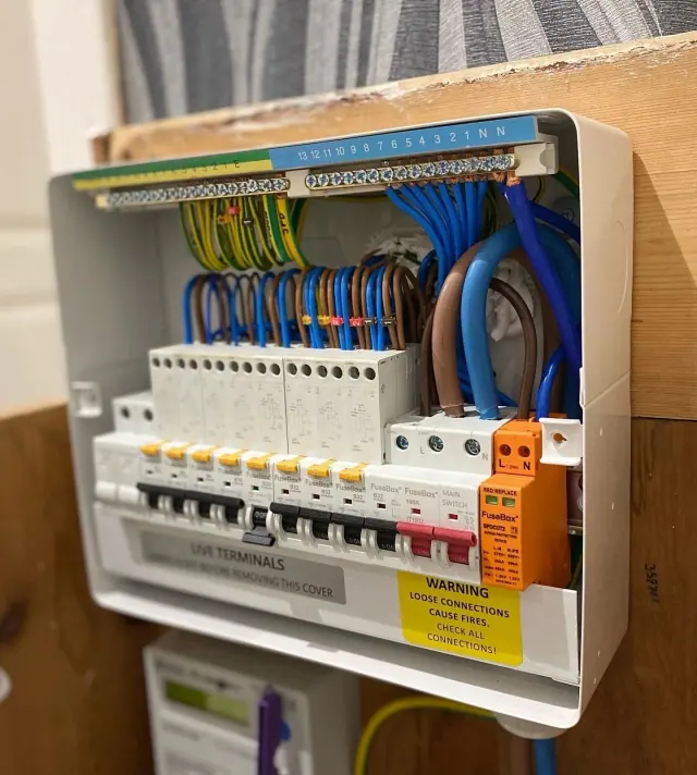 Close-up of electrical circuit breakers with connected wires.